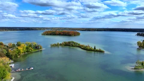 Aerial drone captures stunning fall colors at Orchard and Cass Lakes in Michigan Stock Footage 220035268