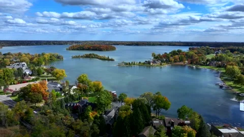 Aerial drone captures stunning fall colors at Orchard and Cass Lakes in Michigan Stock Footage 220035269
