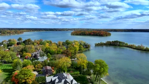 Aerial drone captures stunning fall colors at Orchard and Cass Lakes in Michigan Video stock 220035277