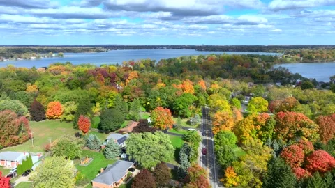 Aerial drone captures stunning fall colors at Orchard and Cass Lakes in Michigan Stock Footage 220035281