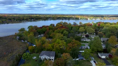 Aerial drone captures stunning fall colors at Orchard and Cass Lakes in Michigan Stock Footage 220035294