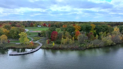 Aerial drone captures stunning fall colors at Orchard and Cass Lakes in Michigan Stock Footage 220035295