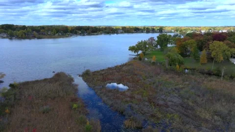 Aerial drone captures stunning fall colors at Orchard and Cass Lakes in Michigan Stock Footage 220035306