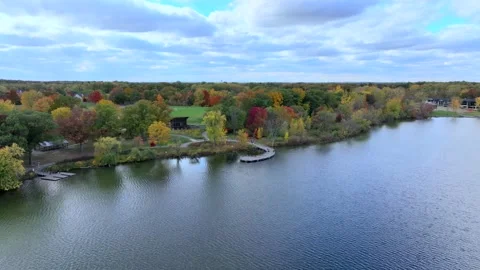 Aerial drone captures stunning fall colors at Orchard and Cass Lakes in Michigan Stock Footage 220035307