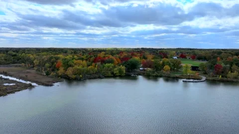 Aerial drone captures stunning fall colors at Orchard and Cass Lakes in Michigan Stock Footage 220035308