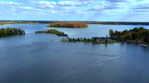 Aerial drone captures stunning fall colors at Orchard and Cass Lakes in Michigan Video stock 220035310
