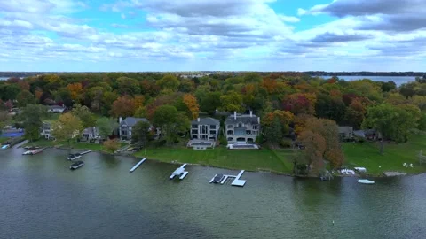 Aerial drone captures stunning fall colors at Orchard and Cass Lakes in Michigan Stock Footage 220035314