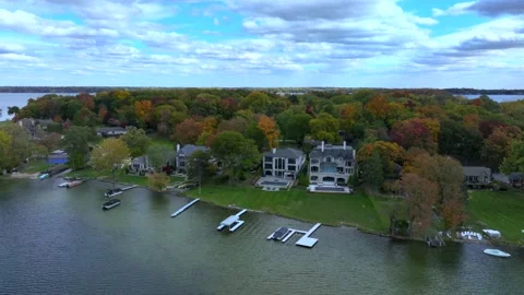 Aerial drone captures stunning fall colors at Orchard and Cass Lakes in Michigan Stock Footage 220035317