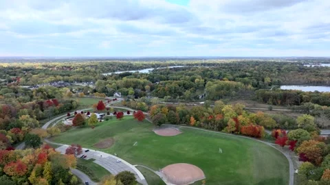 Aerial drone captures stunning fall colors at Orchard and Cass Lakes in Michigan Stock Footage 220035323