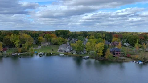 Aerial drone captures stunning fall colors at Orchard and Cass Lakes in Michigan Video stock 220035329