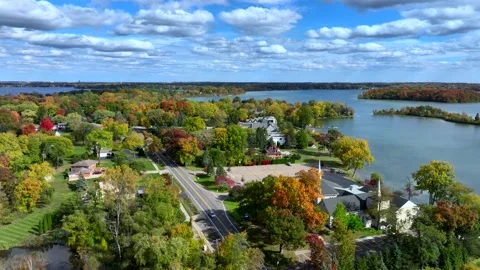Aerial drone captures stunning fall colors at Orchard and Cass Lakes in Michigan Stock Footage 220035336