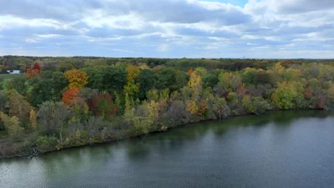 Aerial drone captures stunning fall colors at Orchard and Cass Lakes in Michigan Stock Footage 220035337