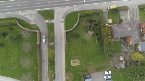 Aerial Drone car pulls out and travels along busy dual carriageway Stock Footage 105743144