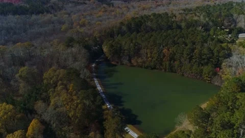 Aerial drone circle view green triangle lake and trees riverdale ga. Stock Footage 170457368