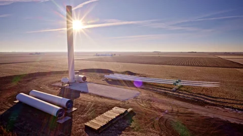 Aerial drone circling active wind turbine construction Stock Footage 329220975