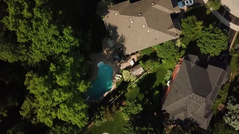 Aerial drone clip, top down, low altitude, of a suburb in summer. Video stock 90467131