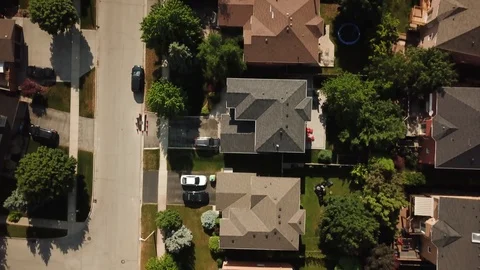 Aerial drone clip, top down, low altitude, of a suburb in summer. Video stock 90467340