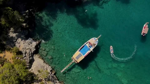 Aerial drone close up view to clear blue sea water with moored boats and yachts Stock Footage 169579521