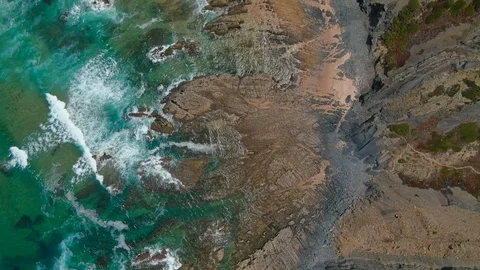 Aerial drone close up view of ocean waves moving Aljezur Algarve coastline beach Stock Footage 114309400