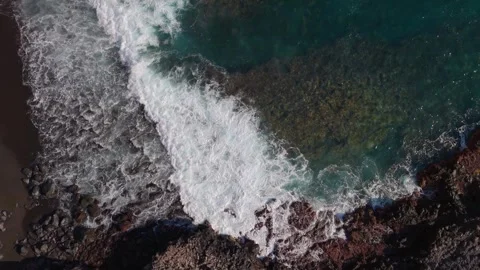 Aerial Drone Descending Toward Waves on Volcanic Lava Coast, Tenerife Stock Footage 336280312