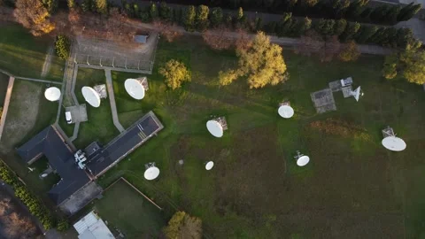 Aerial drone descending view over network of parabolic antennas in Stock Footage 197986393