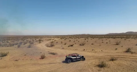 AERIAL DRONE OF DUNE BUGGY DRIVING AT SPEED IN DESERT Stock Footage 127474501