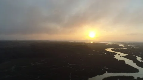 Aerial Drone elevation through clouds with Marsh/Waterway views. Video stock 89785041