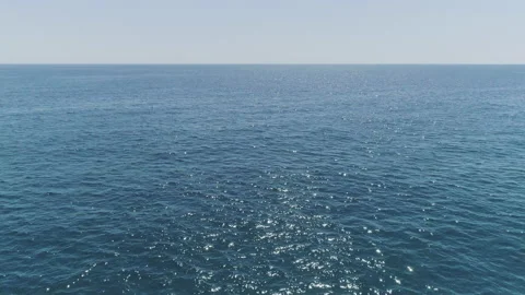 AERIAL DRONE EMPTY CALM BLUE SEA WITH BEAUTIFUL SUN REFLECTION Stock Footage 130433591