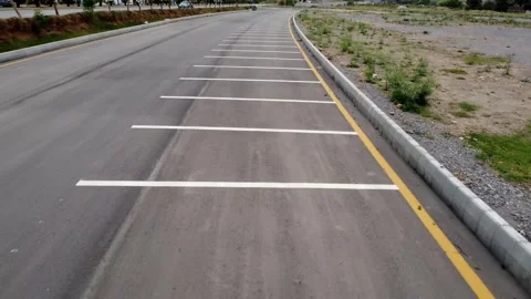 Aerial Drone Empty Parking Lot Next Busy Double Lane Road 4K Stock Footage 306224043