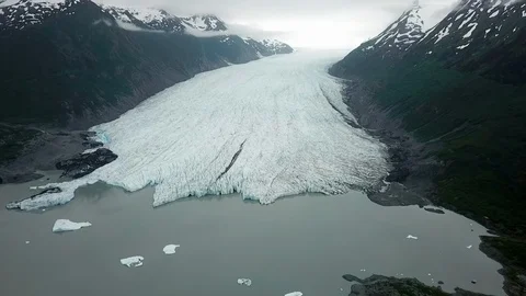 Aerial Drone of Extensive White Glacier Between Two, Dark and Foreboding Stock Footage 101100070