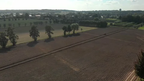 Aerial drone field farmer plot tractor agriculture work crop sunset plow plowing Stock Footage 212453999