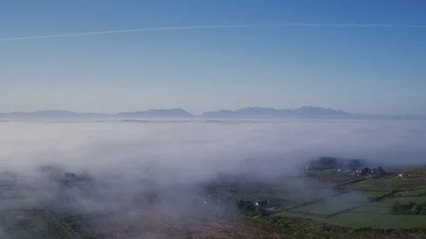 Aerial Drone Of Fields Covered With Clouds Against Vapor Trail Stock Footage 79654630