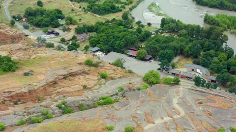Aerial drone flies forward above Uplistsikhe in Georgia, crossing carved rock Stock Footage 340765077