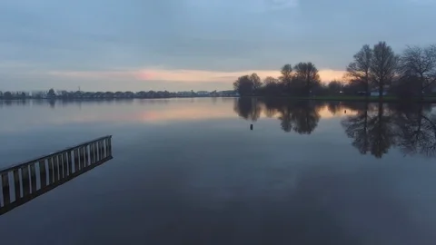 Aerial drone flies over a beautiful lake at sunset. Stock Footage