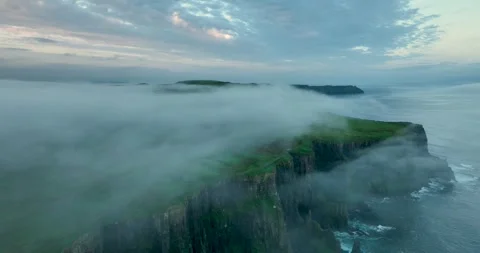 Aerial drone flight above Cliffs of Moher with low clouds drifting over sea Stock Footage 339507546