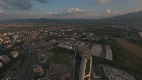 Aerial drone flight above modern skyscraper revealing Sofia at sunset, Bulgaria. Stock Footage 340201308