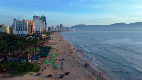 Aerial drone flight along Da Nang beach with morning waves and skyline Stock Footage 340536468