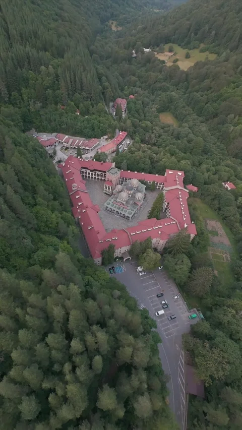 Aerial drone flight approaching Rila Monastery surrounded by forest in Bulgaria. 스톡 동영상 343418640