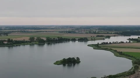 Aerial Drone Flight Backward Over Lednica Lake Revealing Landscape Stock Footage 324976670