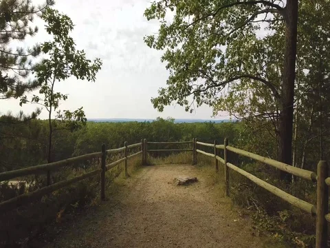 Aerial drone flight down scenic overlook path Stock Footage 80894031
