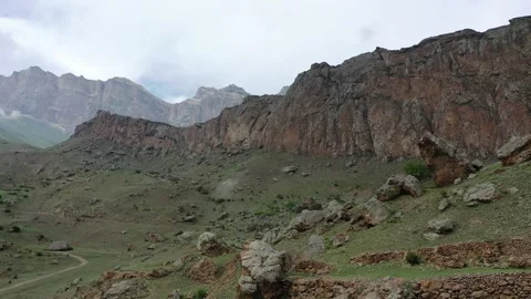 Aerial drone flight forward over the dramatic Bezengi mountain range Stock Footage 338046863