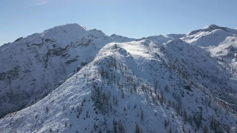 Aerial drone flight heading to the top of the snowy mountain in winter Stock Footage 215874053