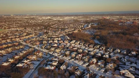 Aerial drone flight low over a suburban community on a bright day in winter. Stock Footage 102203318