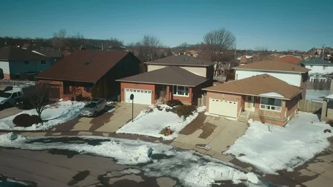 Aerial drone flight low over a suburban community on a bright day in winter Stock Footage 103061683