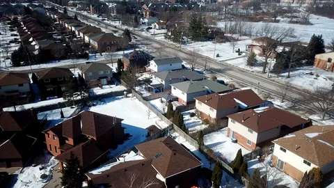 Aerial drone flight low over a suburban community on a bright day in winter Stock Footage 103062065
