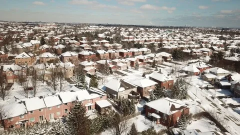 Aerial drone flight low over a suburban community on a bright day in winter. 스톡 동영상 103824280