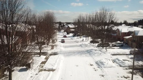 Aerial drone flight low over a suburban community on a bright day in winter. Stock Footage 103824345