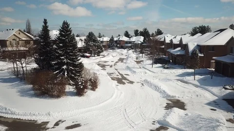 Aerial drone flight low over a suburban community on a bright day in winter. Video stock 103824480