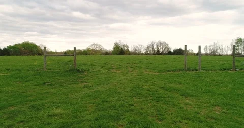 Aerial drone flight low over a large field Stock Footage 106959977