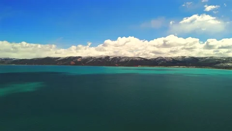 Aerial drone flight over Bear Lake Utah with layered turquoise water Stock Footage 335080536